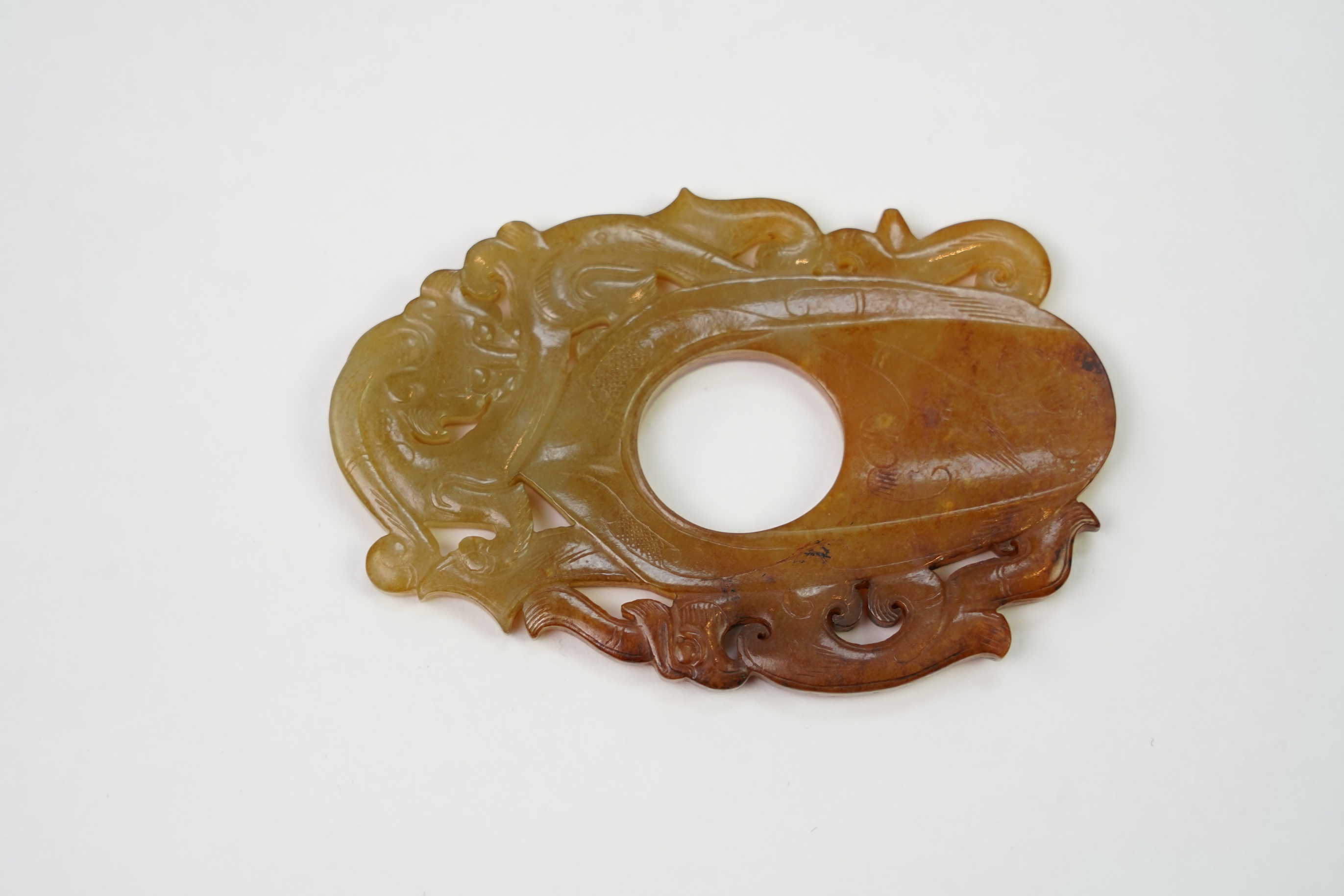 A Chinese archaistic jade plectrum-shaped plaque